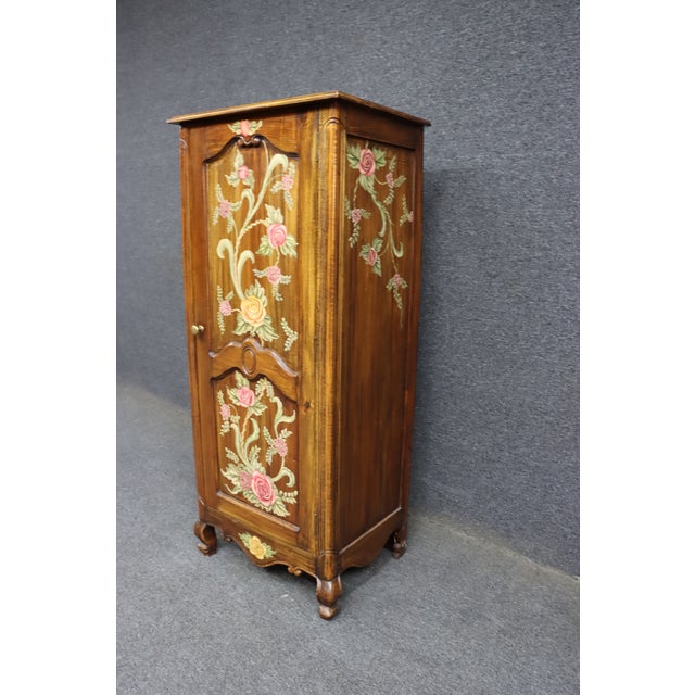Narrow cherry wood chimney cupboard with a single door and hand-painted floral decoration. Features raised panel...