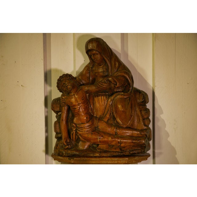Carved oak Pietà in relief, French work from the early 18th century, probably Burgundy with Flemish influence. The seated...