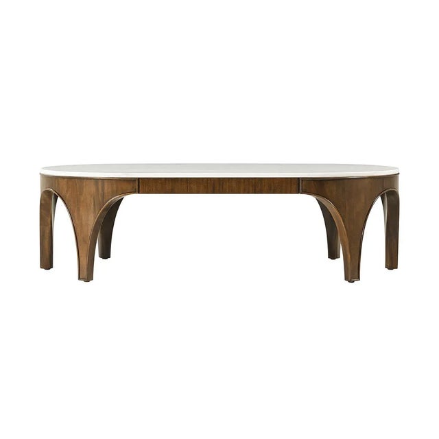 Featuring a raised lip, highlighting the outline of the architecturally inspired legs. This elegant cocktail table,...