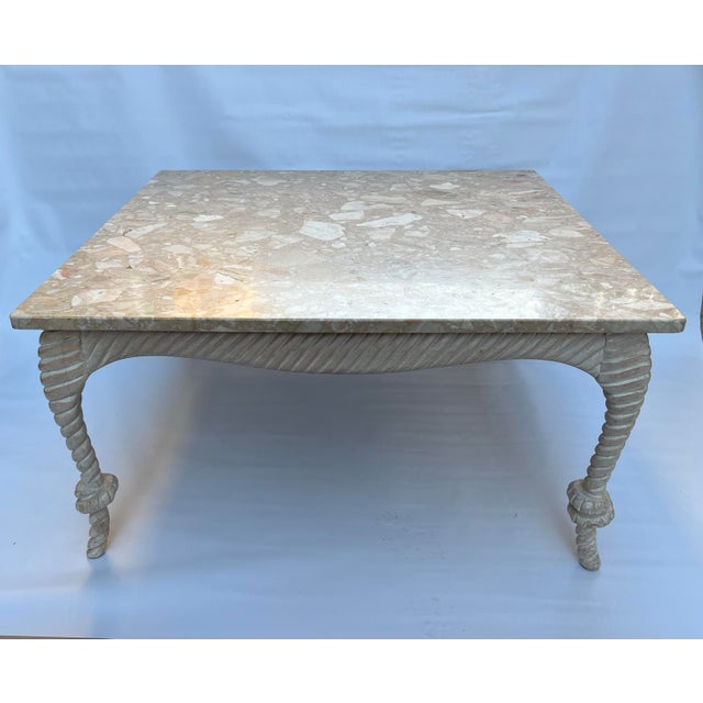 A single vintage square shape coffee table featuring a carved wood frame and stylized rope legs with knots. The removable...
