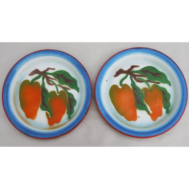 Adorable pair of French Country tole plates with painted peppers, circa 1940. Feature a blue and red trim. Unsigned. Some...