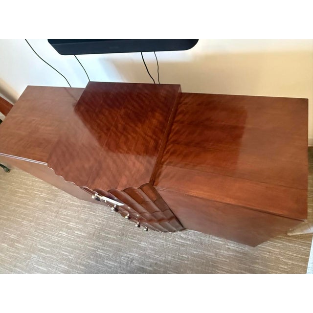 Bold, avant-garde sideboard featuring a dramatic sculptural façade and richly figured walnut veneer. The striking fluted...