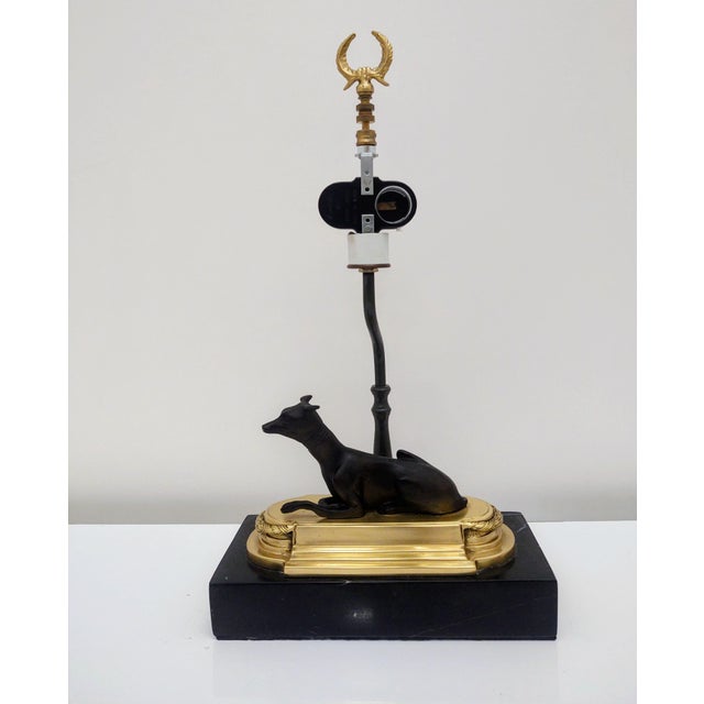 The Chelsea House Whippet (or Greyhound) Bookcase Lamp is a vintage mid-century figural lamp featuring a patinated bronze...