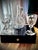 A decorative antique and vintage glassware set consisting of a 19th century claret jug and a pair of later crystal wine...