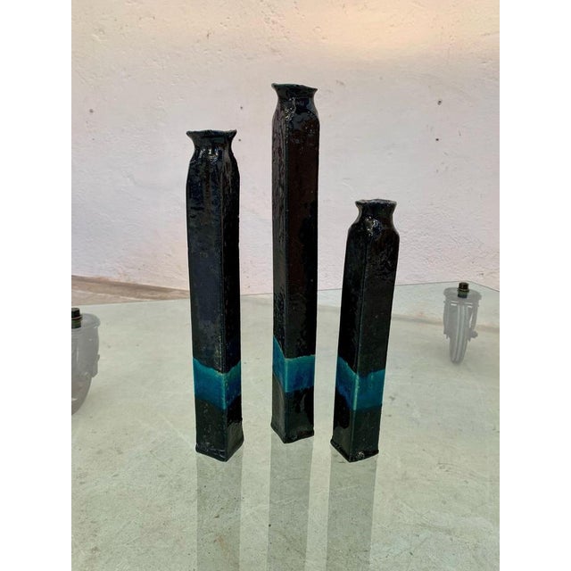 Three Raku ceramic vases glazed and colored, 1970s Three Raku ceramic vases of different heights glazed in dark blue with...