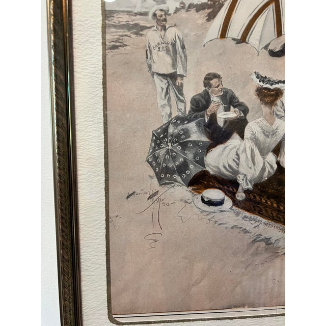 Vintage Harrison Fisher “Picnic at the Beach” print, dated 1903. A charming seaside scene with a group gathered for a...