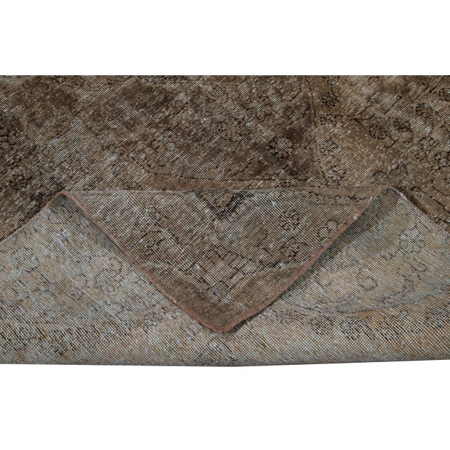 Beautiful hand-knotted vintage wool rug with a brown field. This distressed rug has gray accents featuring an all-over...