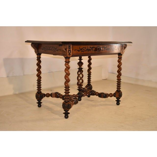 19th century inlaid walnut writing table/desk from France. The top is made from two gorgeous walnut boards, surrounded in...