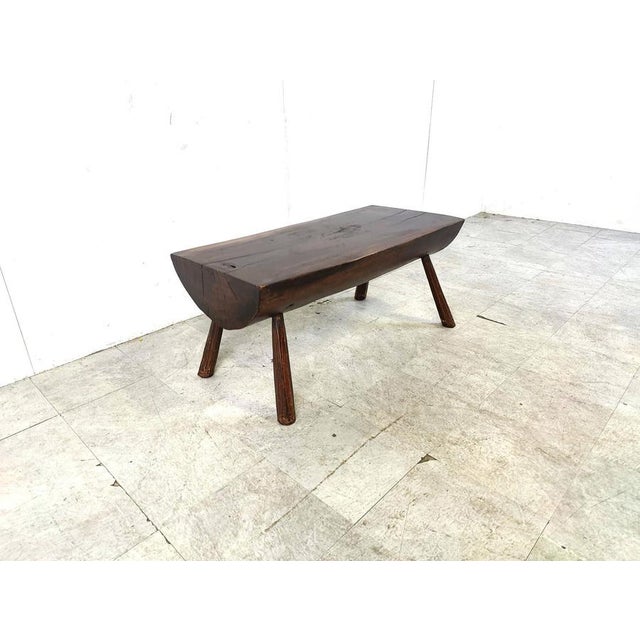 Brutalist 4 legged coffee table with a solid wooden top. Great piece to contrast modern day interiros. Charming patina....