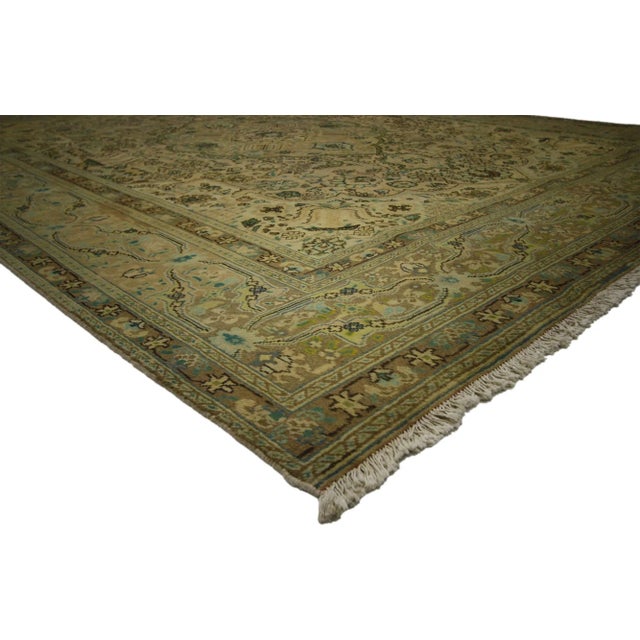 Vintage Persian Tabriz Rug. This hand-knotted wool vintage Persian Tabriz rug features a modern traditional style in light...