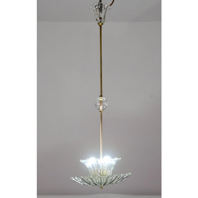 Elegant Murano glass chandelier with brass structure from the mid-20th century. Attributed to the Barovier e Toso...