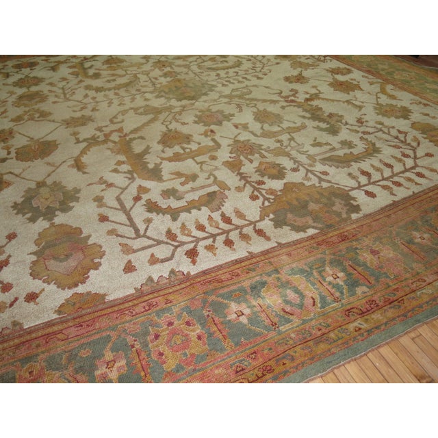 An antique Oversize rare square Oushak rug. Antique white field, soft green border. 18'3'' x 18'4'' Oushak rugs are a...