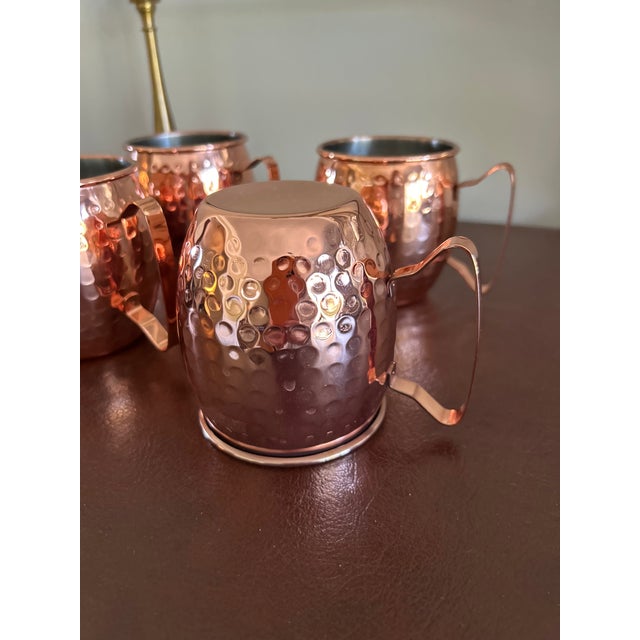 Get your bar cart ready for the holidays with this set of four hammered Moscow Mule mugs. They have a warm, polished...