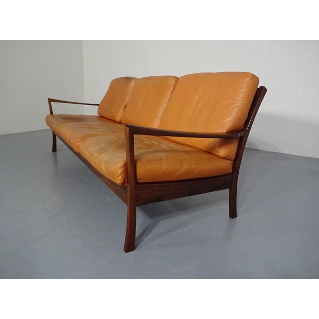 Danish rosewood sofa with loose leather cushions. All cushions have zippers and original down filling. Three matching...