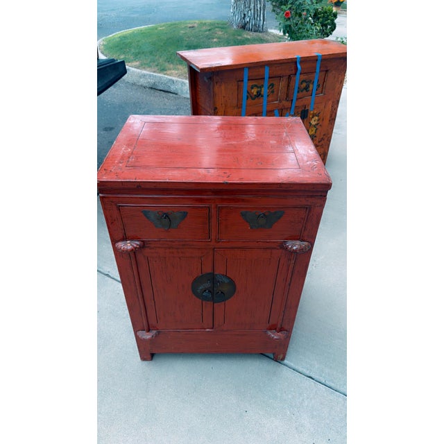 Authentic 19th-century Qing Dynasty Chinese red lacquer cabinet. Handcrafted from solid elm wood, it features a rich,...