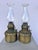 Antique Victorian-era brass oil/kerosene fonts featuring ribbed cylindrical lower reservoirs and embossed decorative...