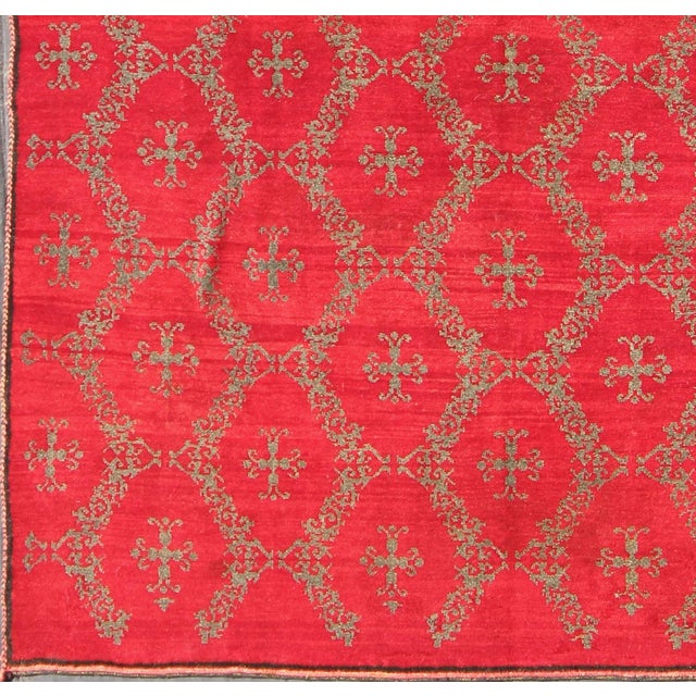 Measures: 6'11'' x 9'1''. This unique Turkish Oushak carpet features an all-over design of vibrant cross shapes,...