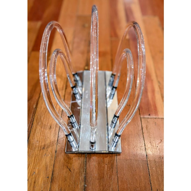 Lucite and chrome magazine rack or record organizer featuring five graduated acrylic arches mounted to a polished chrome...