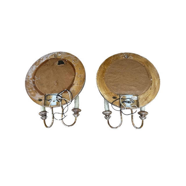 Charming pair of wall sconces from Paul Ferrante with a classic European/Gothic-inspired design. Each features a round...