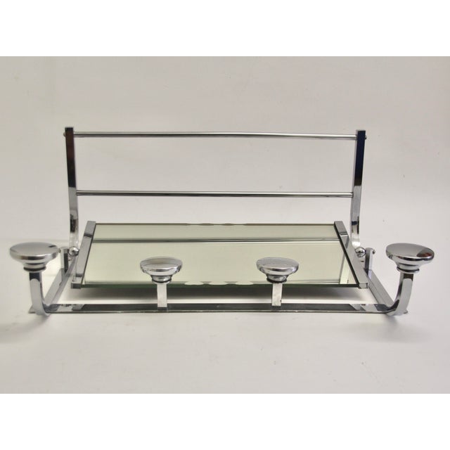 Original Art Deco wall-mounted coat rack from France with a rotating, side-framed mirror. It was made in the 1930s from...