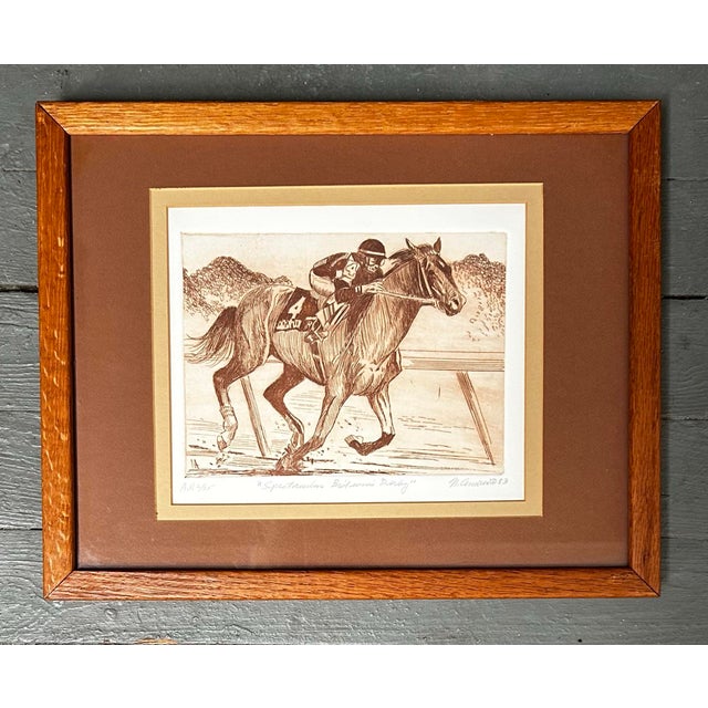 Vintage 1983 artists proof etching entitled “Spectacular Bid Wins Derby”. Depicts a jockey riding famed race horse...