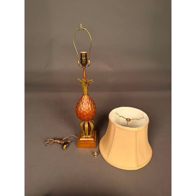 An elegant early 20th-century French table lamp featuring a distinctive pineapple-inspired design, a decorative motif long...