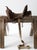 A vintage Western saddle with a beautifully sculptural silhouette, dark aged leather, tooled detailing, and a high cantle....