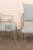 A French set of four aluminum and upholstered dining chairs. These vintage chairs from France each feature elegantly cast...