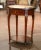 Crafted in France circa 1950 and built of walnut, the oval table sits on four cabriole legs decorated with brass mounts at...