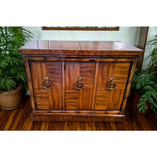 Stunning vintage campaign-style buffet and credenza by Heritage, featuring iconic mid-century craftsmanship and incredible...