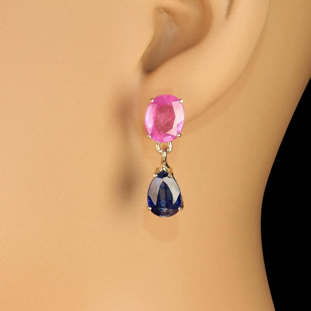 Introducing our Lovely Dangle Earrings, featuring stunning oval pink sapphires weighing 6.64 carats, elegantly paired with...