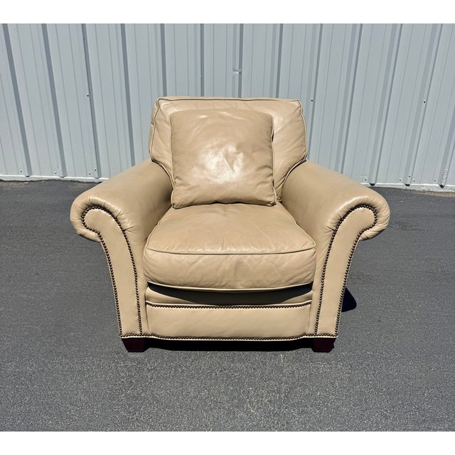 Baker Furniture bench-made club chair with Lawson-style roll-arms and nailhead trim (Model CL-1290). This handsome...