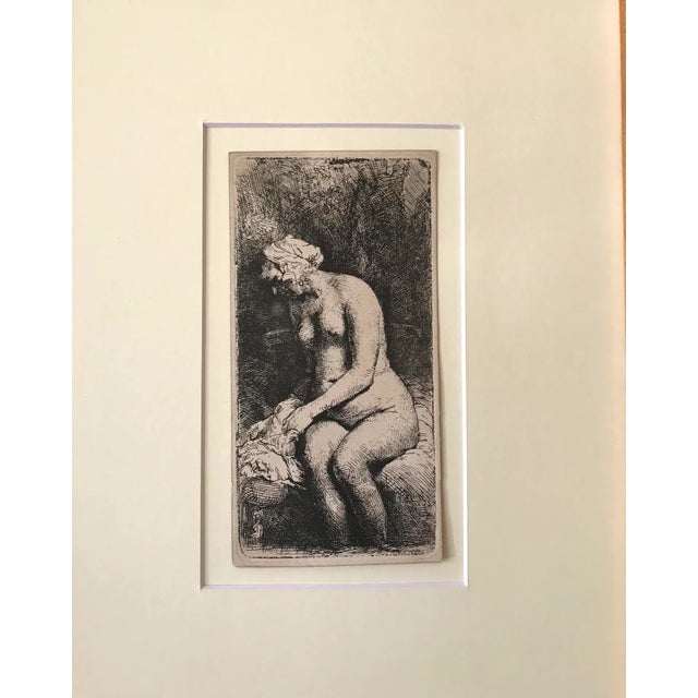 Original antique etching by Rembrandt van Rijn titled Woman Bathing Her Feet in a Brook. Etching, Presented in archival...