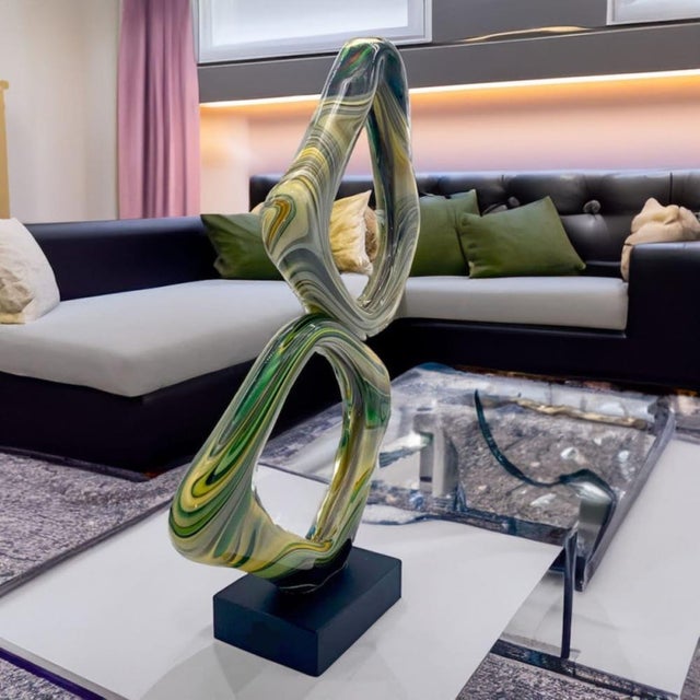 Abstract sculpture in the shape of infinity. A modern design work in Murano glass created to give a unique touch of...
