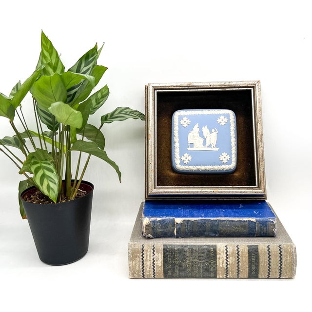 Classic Wedgwood jasperware plaque in the iconic pale blue with crisp white neoclassical relief, housed in a substantial...