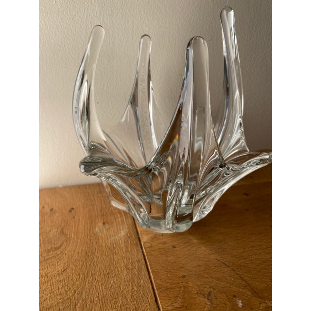 Sculptural clear glass vase, formed by large, twisted, upward-sloping points, creating an organic corolla effect. The...