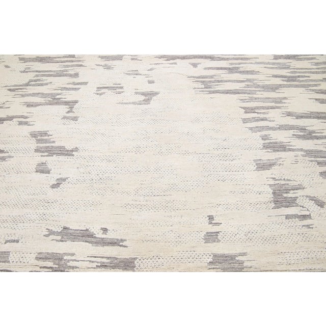Beautiful modern Moroccan-style hand-knotted wool rug with a beige and ivory color field. This rug is part of our...