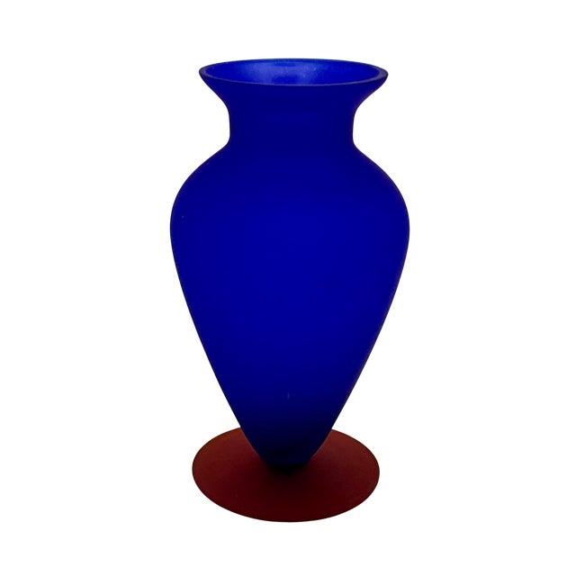 Striking satin glass vase in rich blue with a contrasting brick-red/orange applied base. The exterior is softly matte...