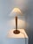 An elegant and simple 20th century French Art Deco wooden table lamp. The solid wood stem tapers down towards the circular...