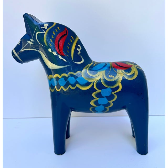 Vintage solid wood Dala horse in hand-painted in ultramarine blue gloss with red, yellow and blue decoration, completed in...