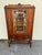 Early 20th Century Jacobean Revival Style Walnut Display China Cabinet It features hand carved t with one drawer and wood...