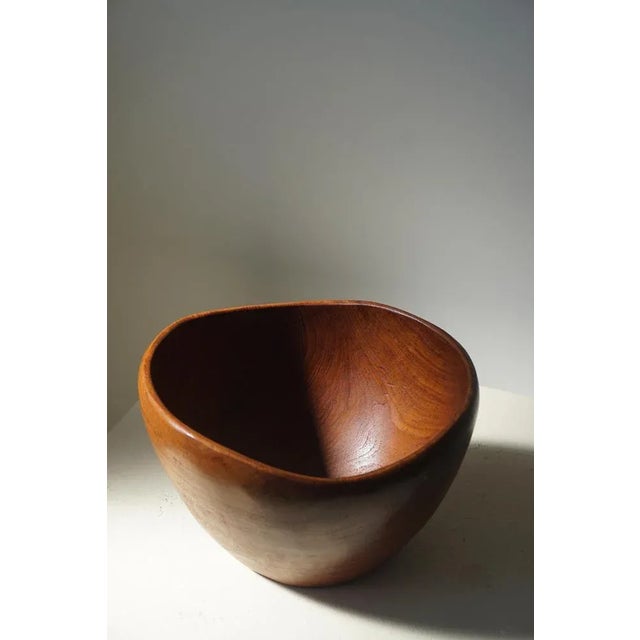 Beautiful patinated bowl in teak. Handcrafted in 1960s. Suits the modern interior.