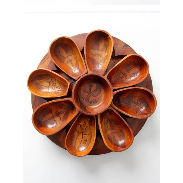 Mid-century carved wood lazy Susan serving tray set featuring a rotating round tray with coordinating individual bowls....