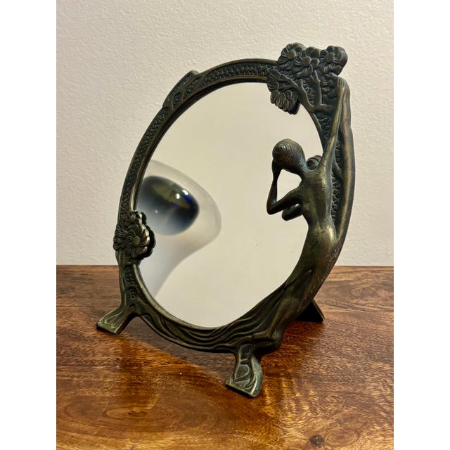 A striking 1960s tabletop vanity mirror in the French Art Nouveau revival style. The sculptural frame features an elegant...