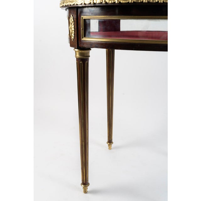 Early 20th-century Louis XVI-style display table. Louis XVI-style display table, early 20th century, gilded bronze, red...