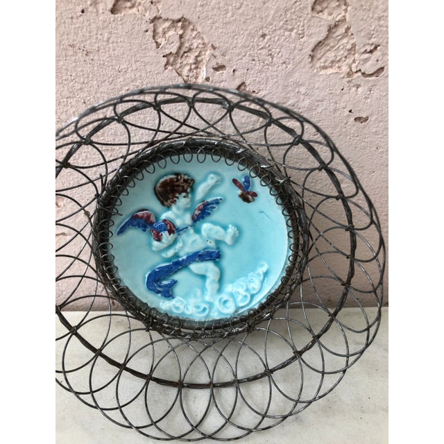 Charming Majolica wire basket with an angel and a butterfly, Circa 1900.