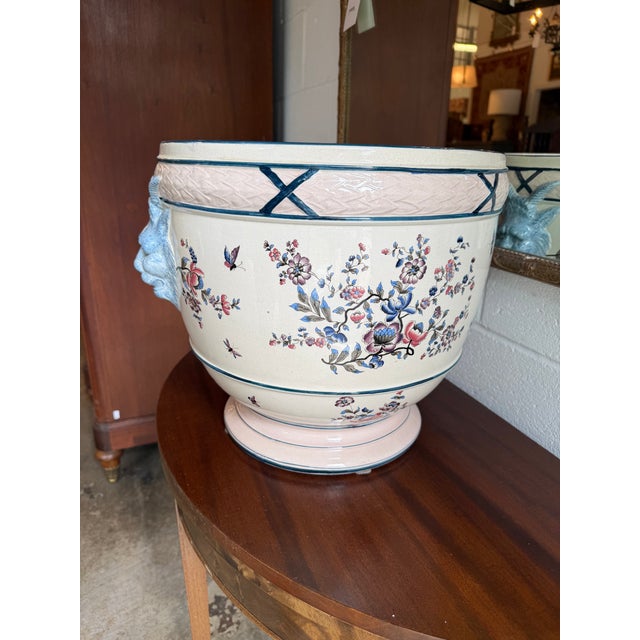 This substantial vintage ceramic cachepot planter features an open, footed urn silhouette decorated in a classic...