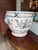 This substantial vintage ceramic cachepot planter features an open, footed urn silhouette decorated in a classic...