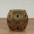 Chic pair of mid century Chinese garden seats crafted in brass, featuring open fretwork floral, geometric and symbolic...