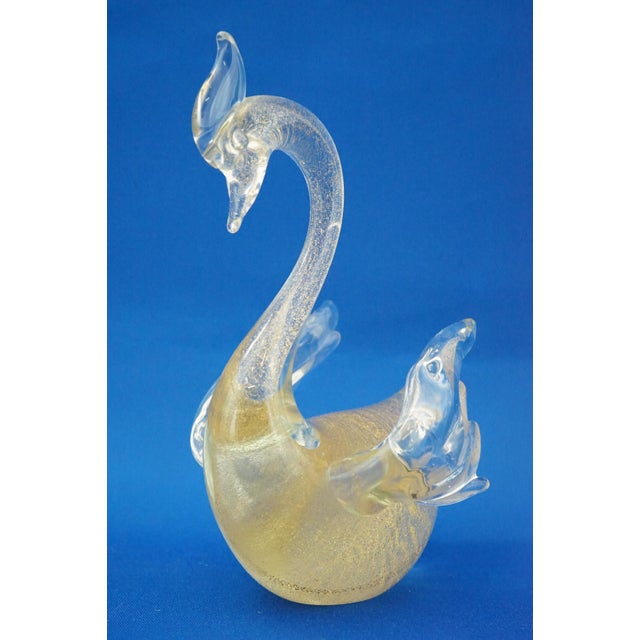 A magnificent clear blown glass sculpture, with aventurine inclusions of gold leaf, depicting a swan. It is unsigned and...